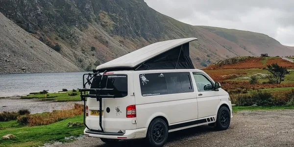 Falcon campervan beside a lake