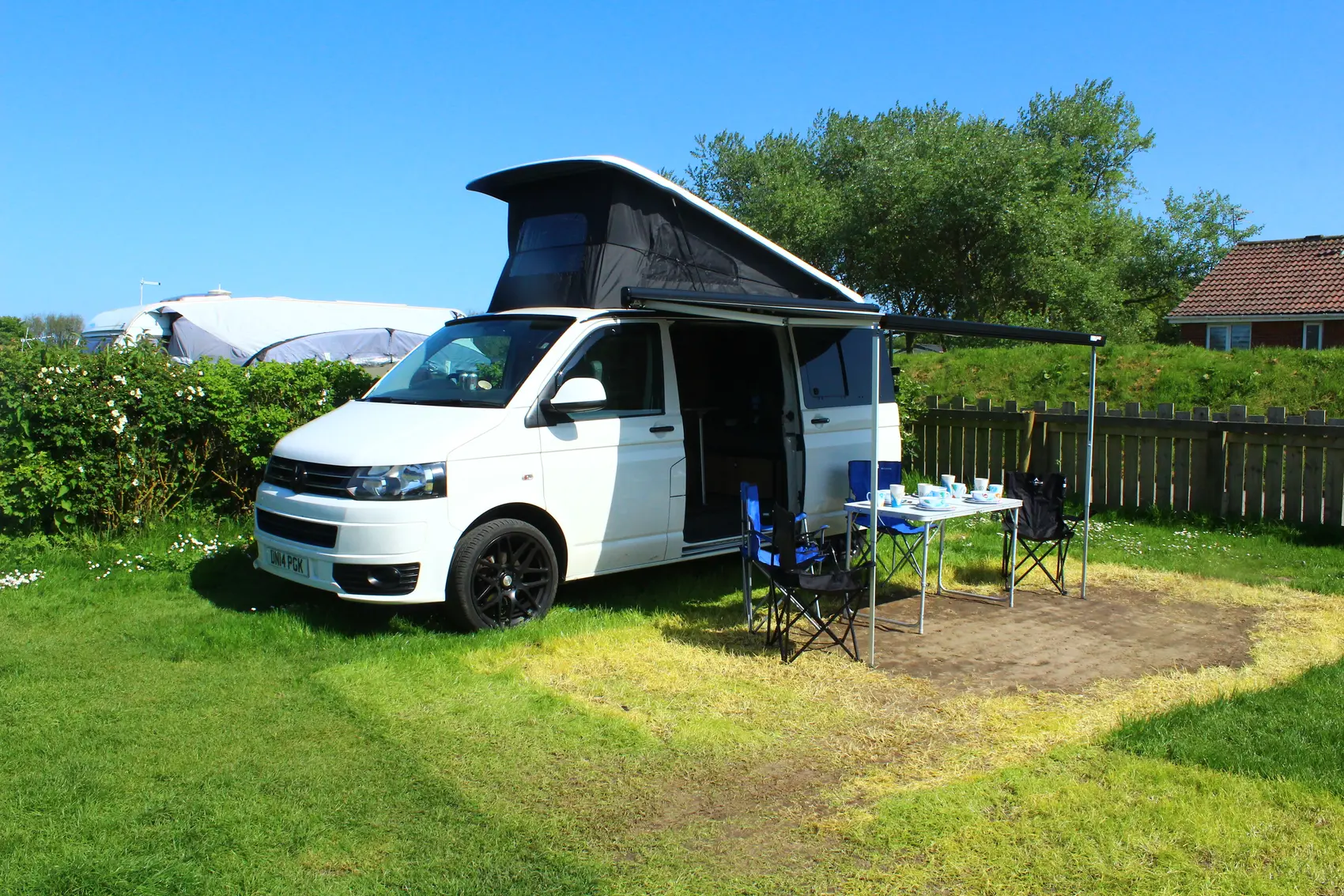 Falcon campervan with awning on a sunny campsite